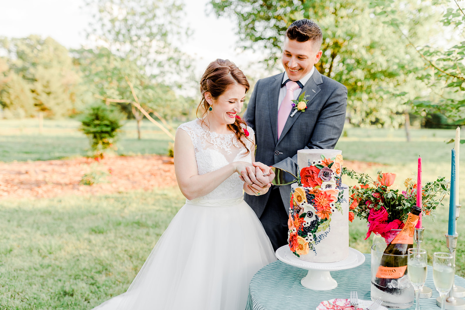 Bright + Cheerful Garden Elegance of Artmosphere — the bride + groom cutting into a 10 Blooms Cakes masterpiece