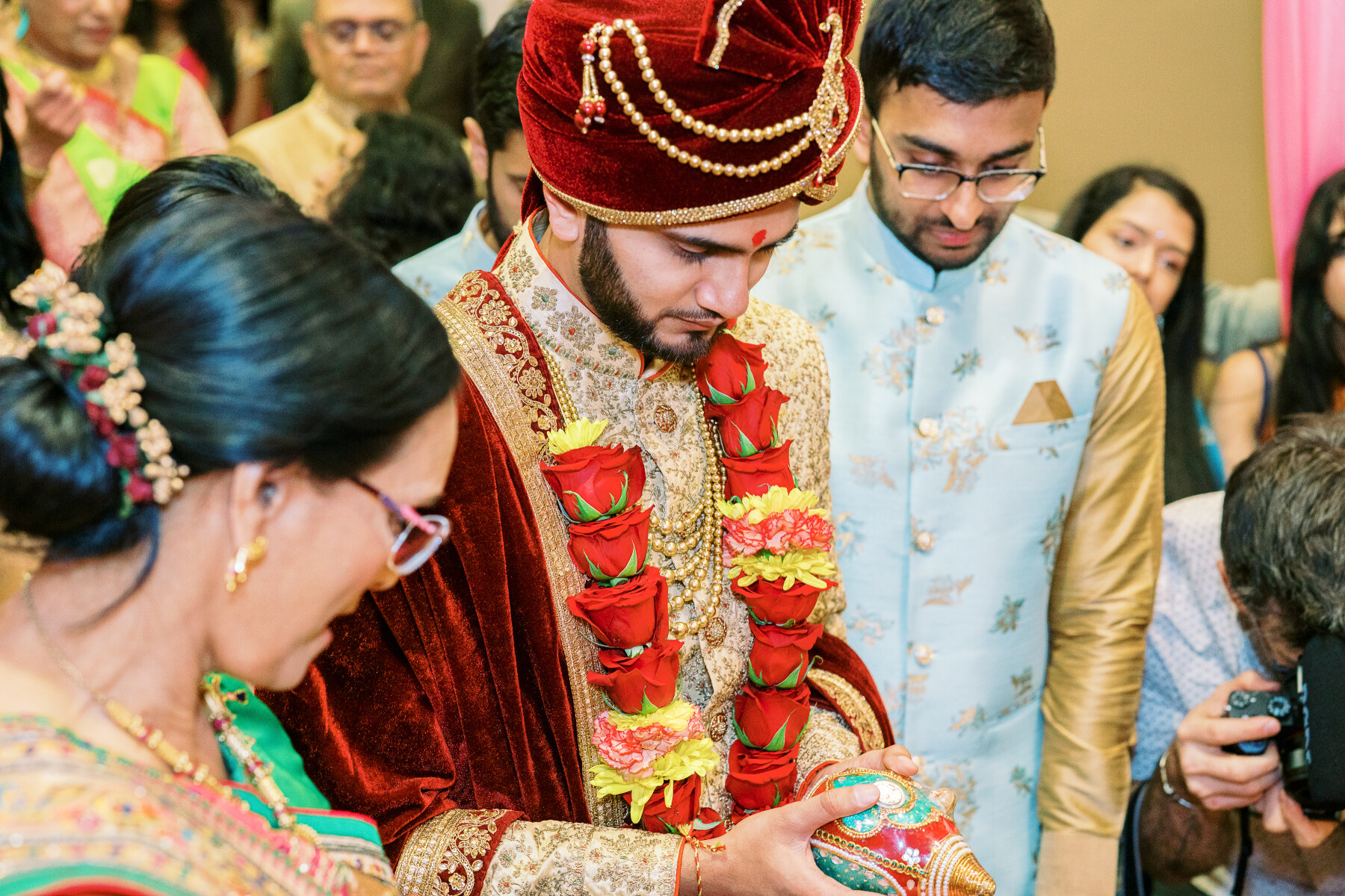 Brides family welcoming Harsh during an South Asian wedding captured by Jamie Vinson Photography