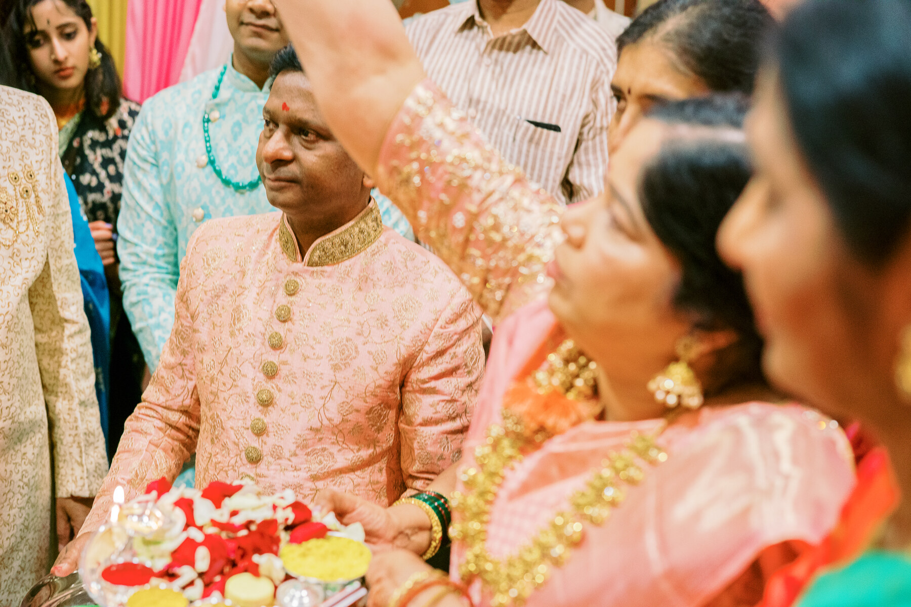 Brides family welcoming Harsh during an South Asian wedding captured by Jamie Vinson Photography
