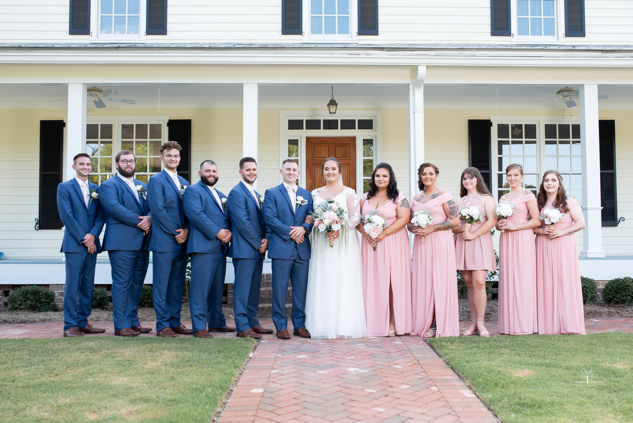 Wedding party photos in front of the Estate House for Samantha and Johnathan's blush, navy, and gold wedding at Walnut Hill.